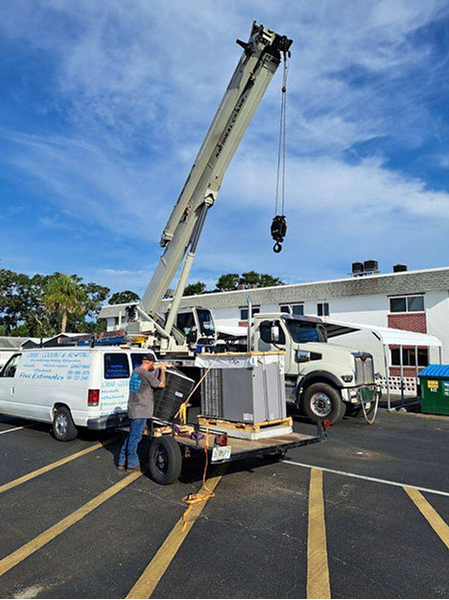 Cubb Cooling and Heating Crane preparing to install an HVAC system